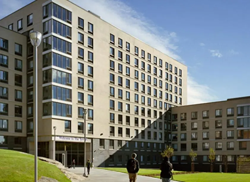 Modern university building with students outside